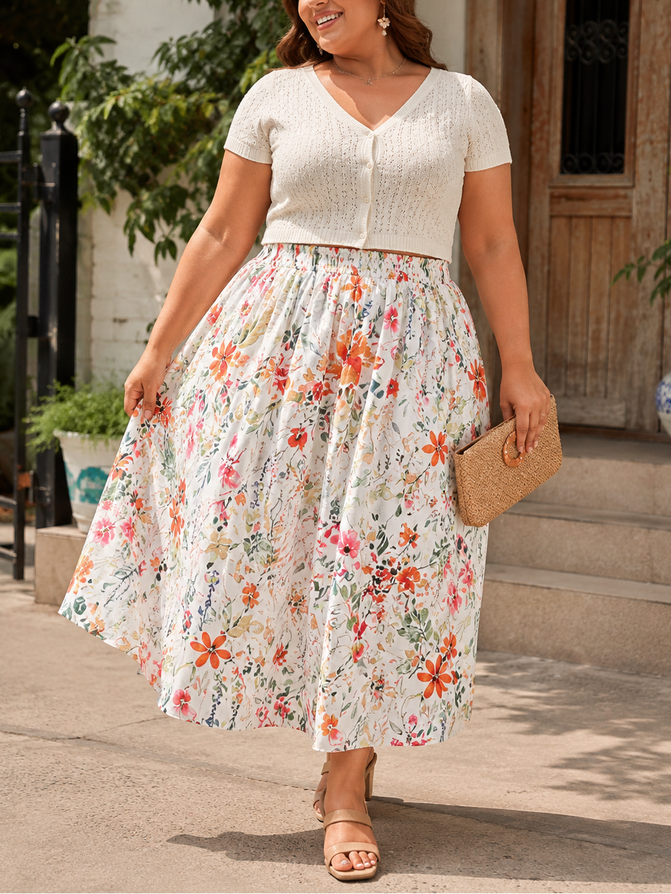 Woman wearing a floral dress and white top outdoors.